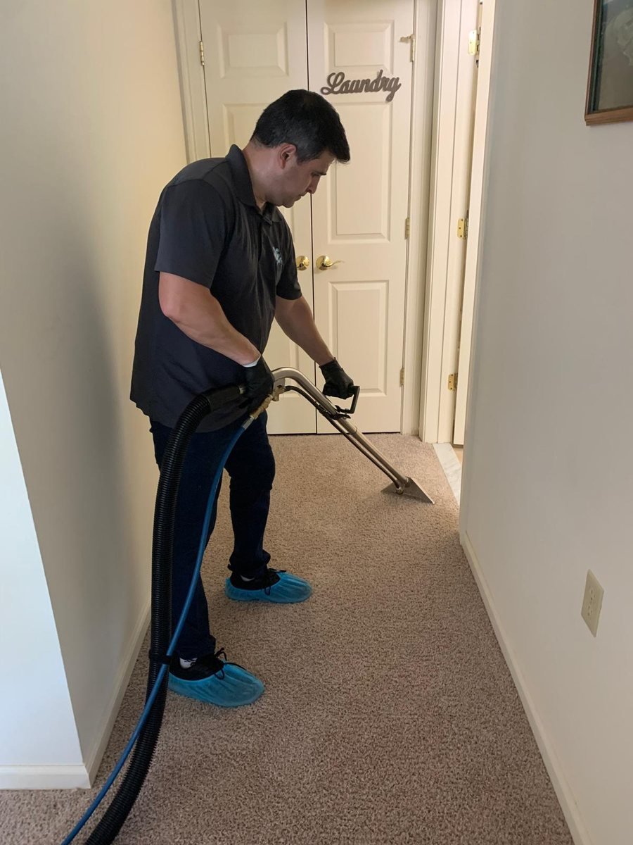 Alex extracting a hallway carpet