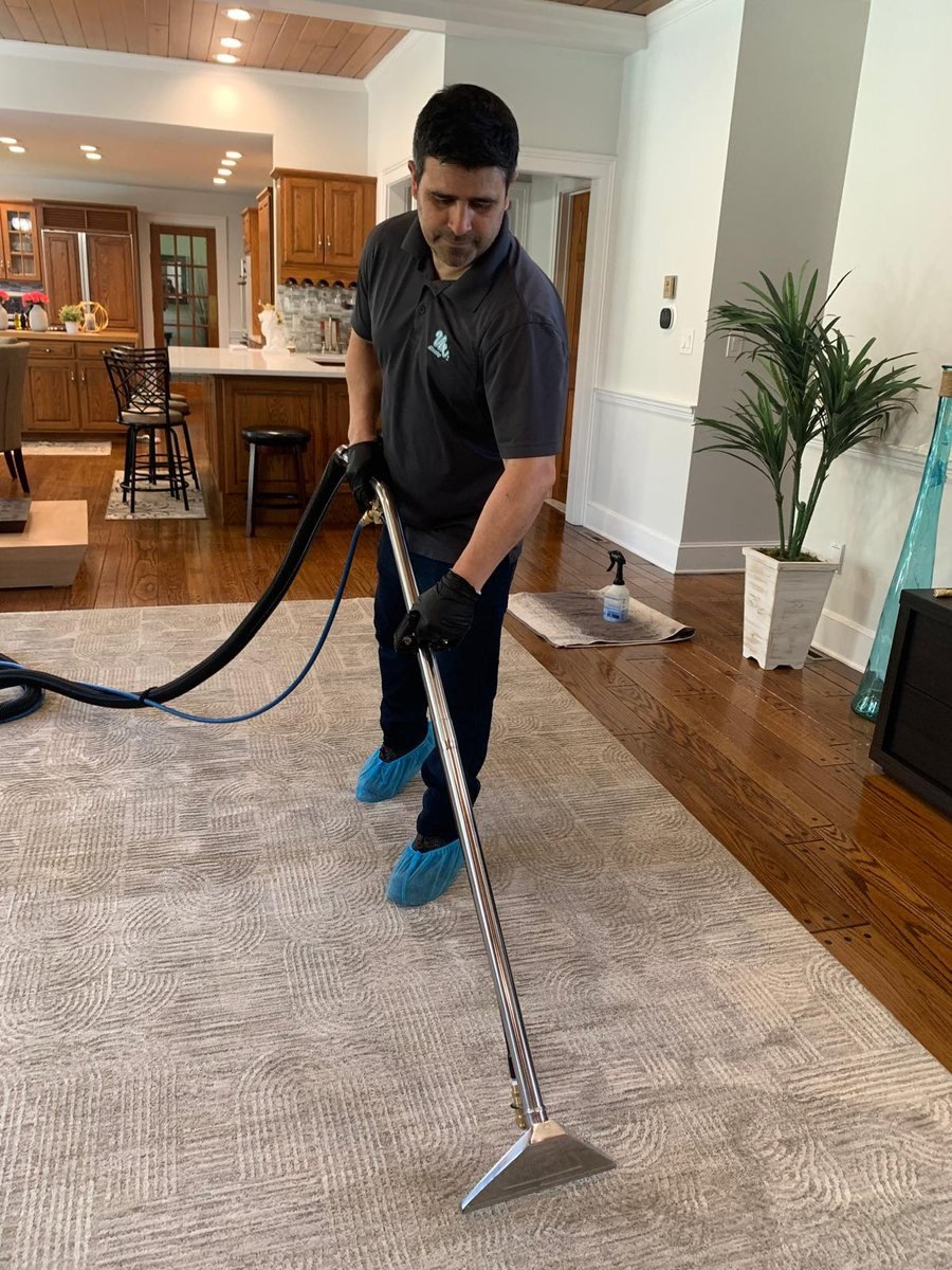 Alex steam-extracting a living room carpet in a Connecticut home